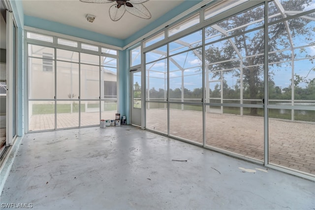 unfurnished sunroom with ceiling fan