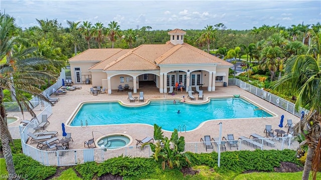 view of swimming pool with a hot tub and a patio