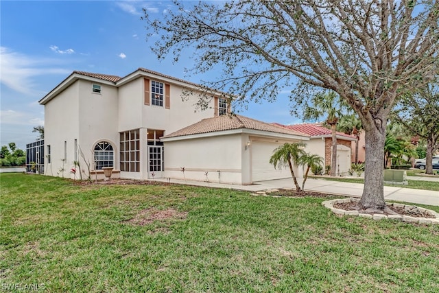 view of front of house with a garage and a front lawn