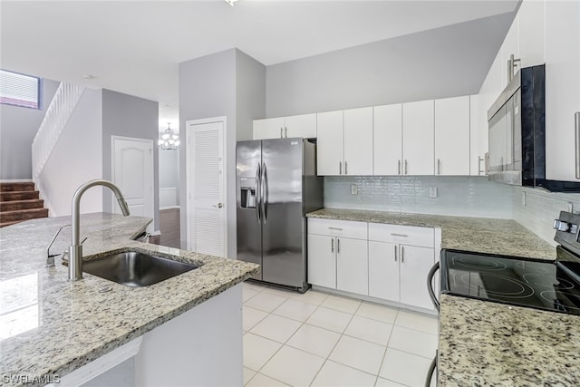 kitchen with stainless steel fridge with ice dispenser, sink, backsplash, and white cabinetry