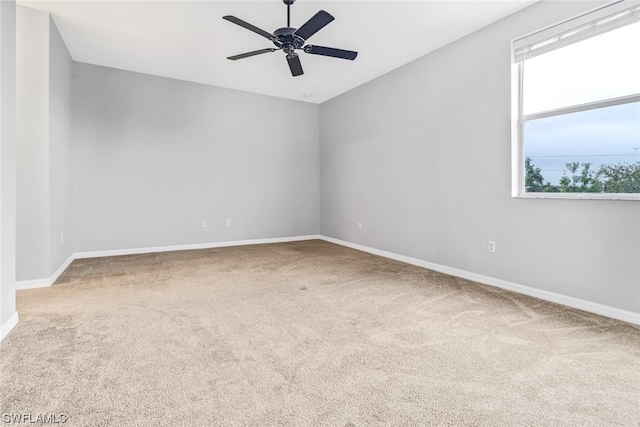 spare room featuring ceiling fan and carpet flooring