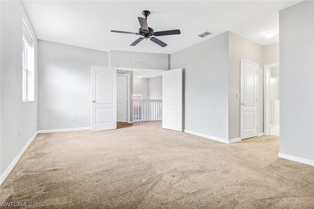 carpeted empty room featuring ceiling fan