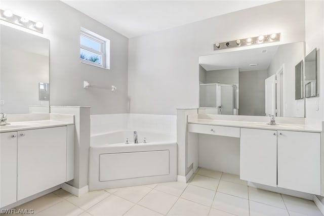 bathroom with a bathtub, tile floors, and vanity