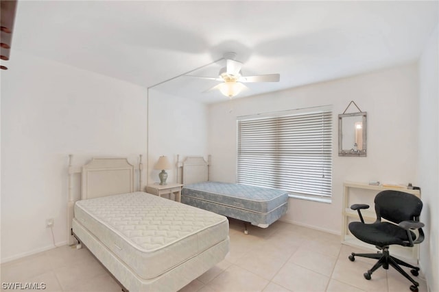 tiled bedroom featuring ceiling fan