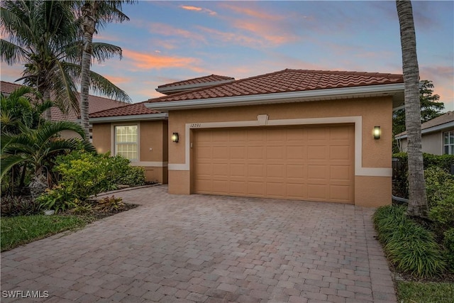 mediterranean / spanish-style house with a garage