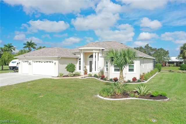 view of front of property featuring a garage and a front yard