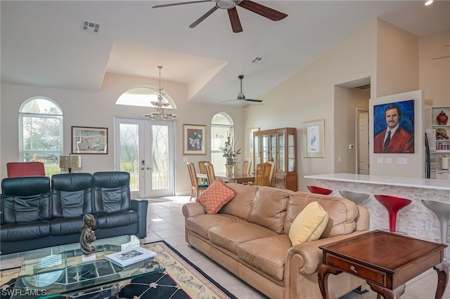 living room featuring french doors, light tile patterned floors, high vaulted ceiling, and an inviting chandelier