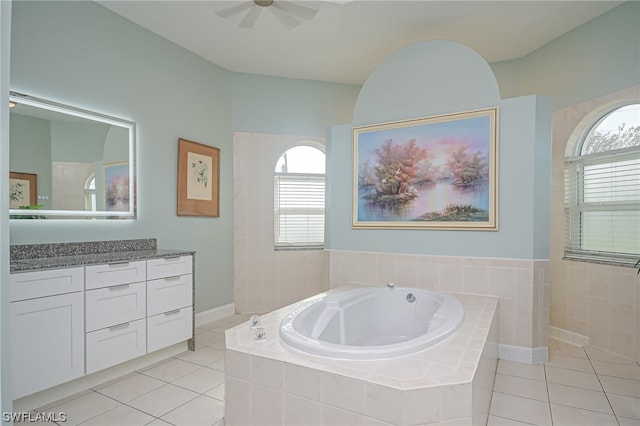 bathroom with tiled bath, tile patterned floors, and plenty of natural light