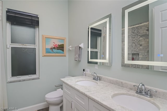 bathroom with vanity, curtained shower, and toilet