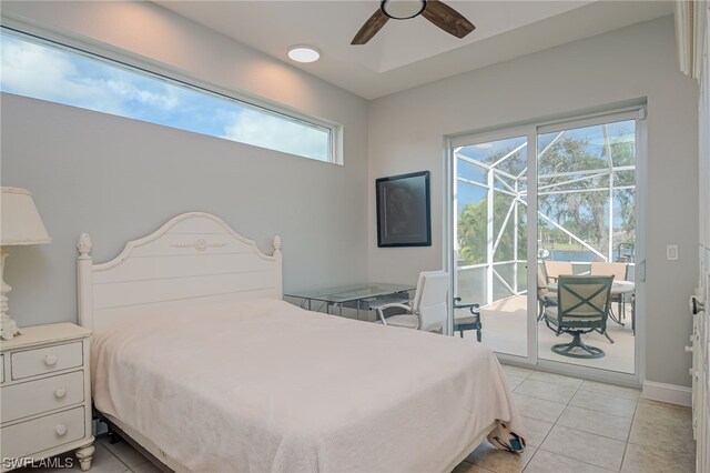 bedroom with ceiling fan, light tile patterned floors, and access to outside