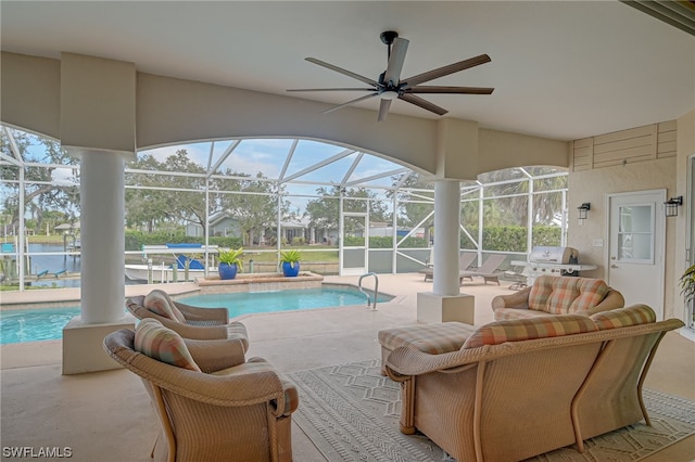 view of swimming pool with glass enclosure, an outdoor living space, grilling area, a water view, and a patio