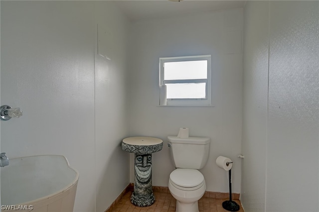 bathroom featuring tile patterned flooring and toilet