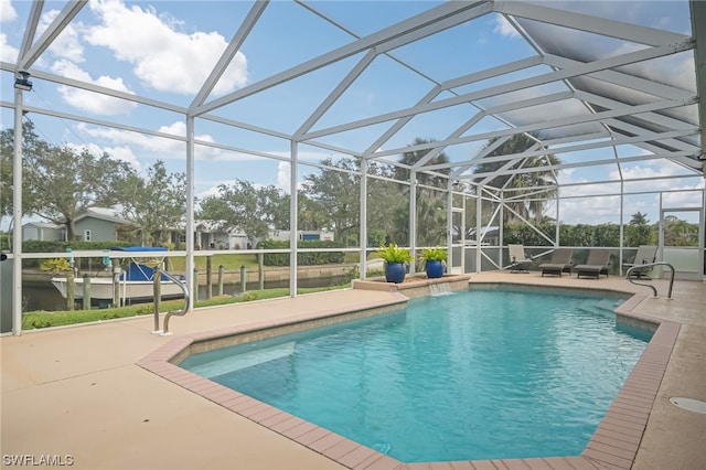 view of swimming pool featuring outdoor lounge area, glass enclosure, and a patio