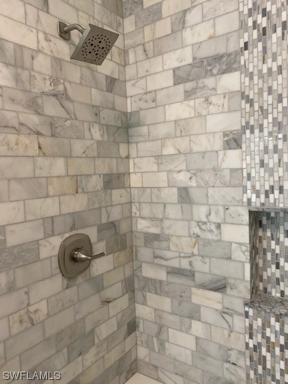 bathroom with a tile shower