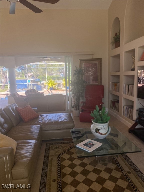 living room featuring built in features and ceiling fan