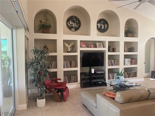 tiled living room with built in shelves and ceiling fan