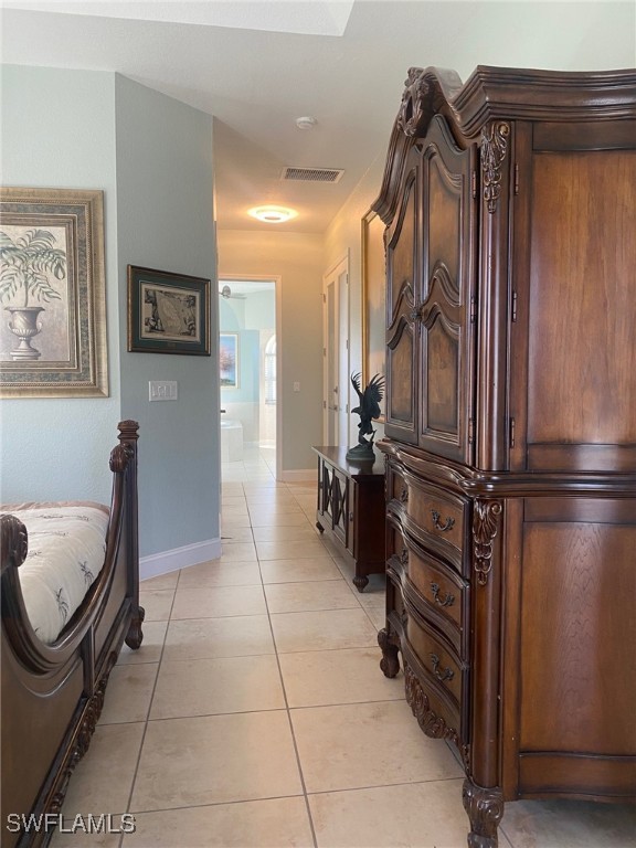 hall featuring light tile patterned flooring