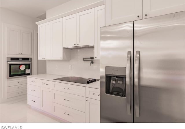 kitchen featuring white cabinets, light tile floors, and appliances with stainless steel finishes