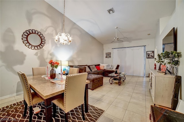 dining space with lofted ceiling, light tile floors, and ceiling fan with notable chandelier