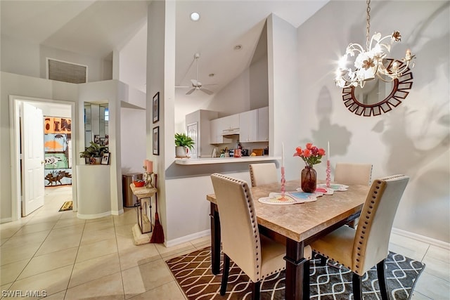 dining room with light tile floors, high vaulted ceiling, and ceiling fan with notable chandelier