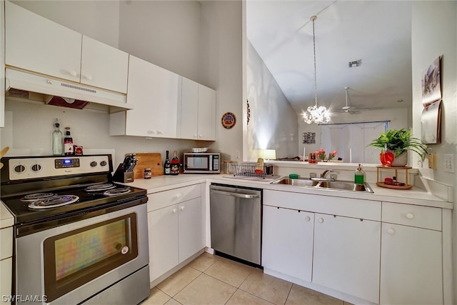 kitchen featuring sink, premium range hood, stainless steel appliances, white cabinets, and a chandelier