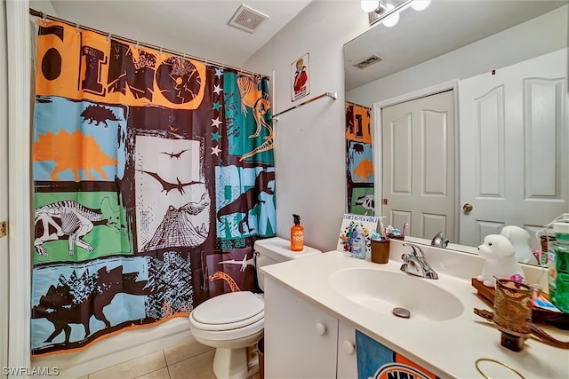 bathroom with tile flooring, oversized vanity, and toilet