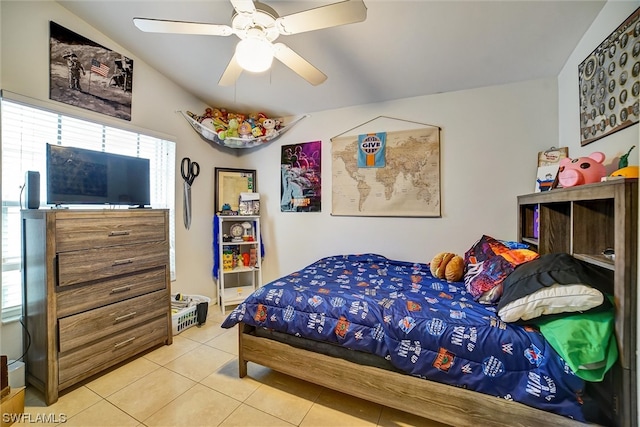 tiled bedroom featuring lofted ceiling and ceiling fan