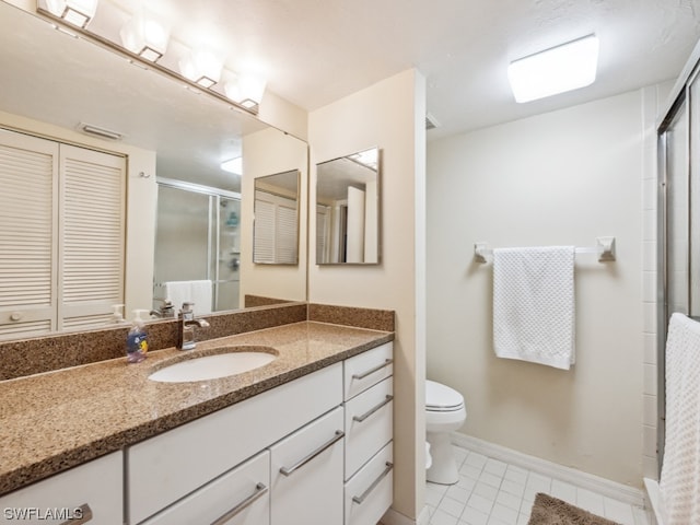 bathroom featuring toilet, tile flooring, walk in shower, and oversized vanity