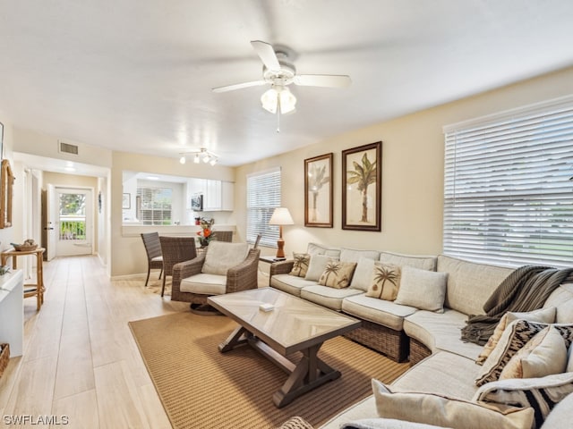 living room with light hardwood / wood-style floors and ceiling fan