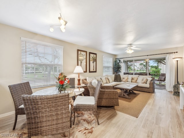 living room featuring ceiling fan and light wood-type flooring