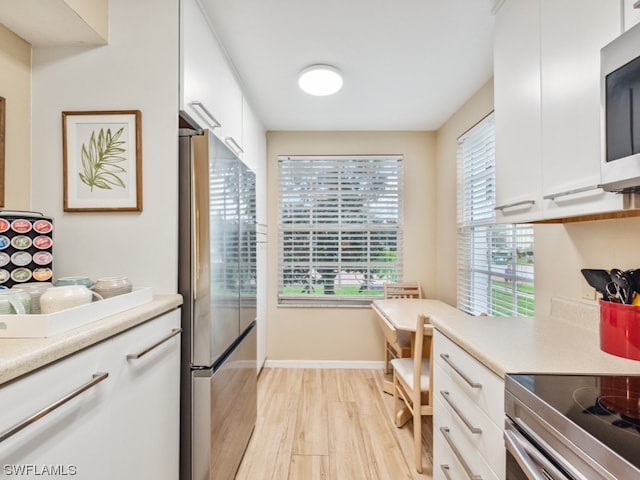 kitchen featuring white cabinetry, light hardwood / wood-style floors, and stainless steel appliances