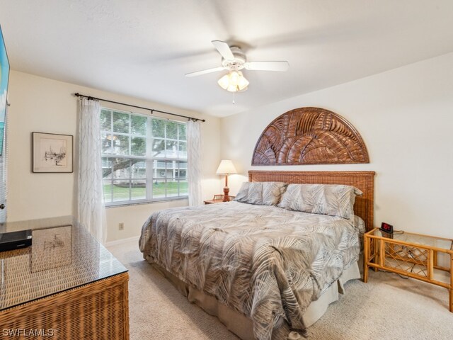 bedroom with light colored carpet and ceiling fan