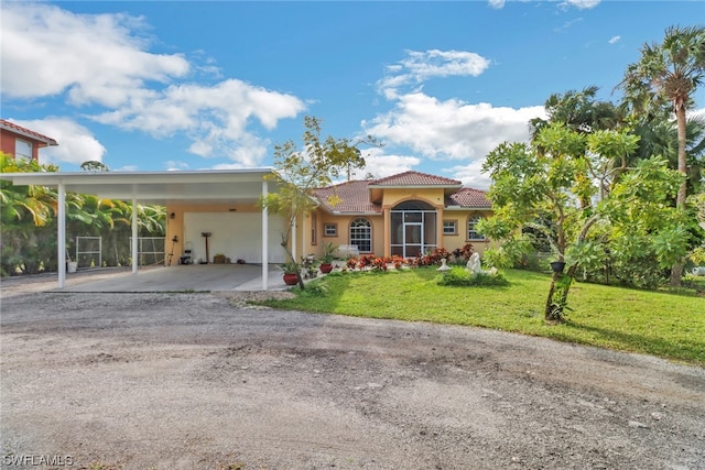 view of front of house with a front yard and a carport