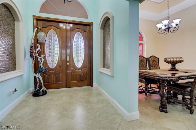 foyer entrance with a notable chandelier and light tile floors