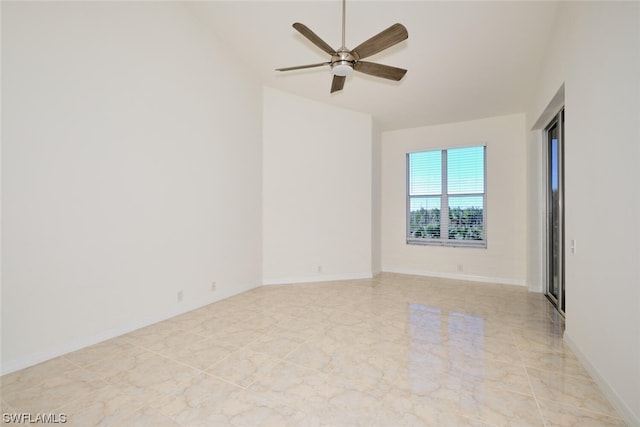 tiled spare room with ceiling fan