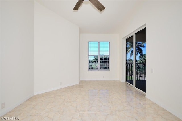 empty room featuring light tile floors and ceiling fan