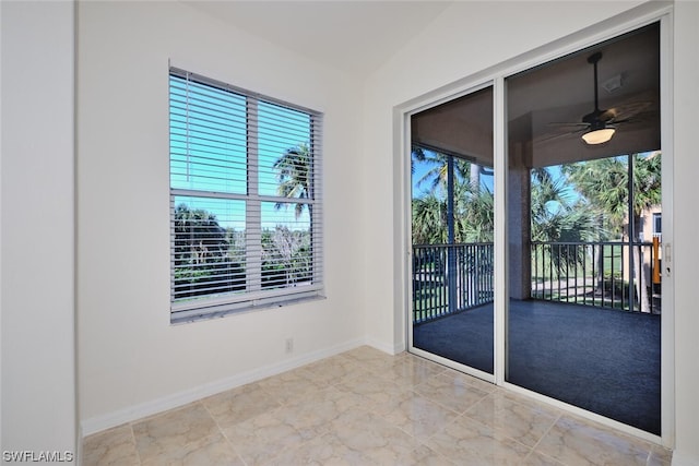 tiled spare room with plenty of natural light and ceiling fan