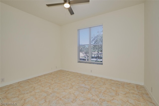 spare room featuring ceiling fan and light tile flooring