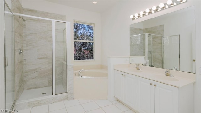 bathroom featuring tile patterned flooring, shower with separate bathtub, and vanity