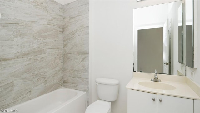 full bathroom featuring tiled shower / bath, vanity, and toilet