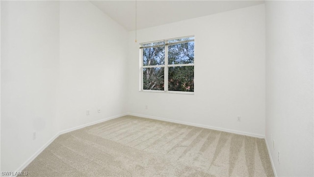 empty room featuring lofted ceiling and carpet floors