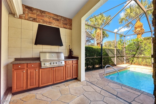 view of swimming pool with grilling area, a patio area, exterior kitchen, and glass enclosure