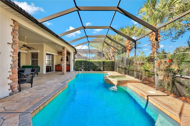 view of swimming pool with ceiling fan, a patio area, a lanai, and an in ground hot tub