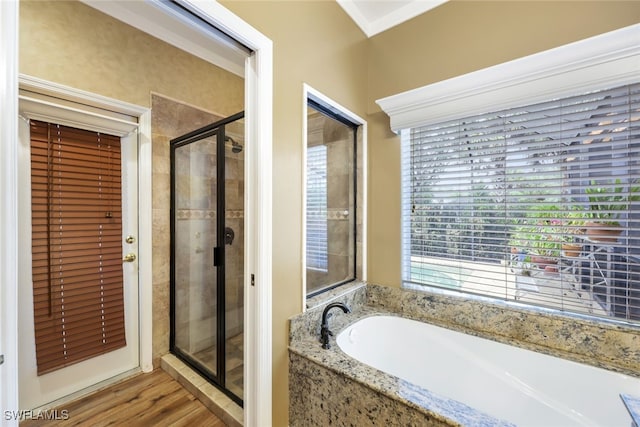 bathroom featuring separate shower and tub and hardwood / wood-style flooring