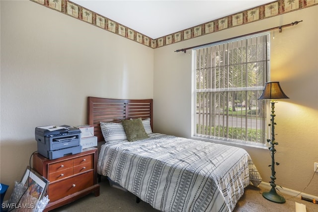 carpeted bedroom featuring multiple windows