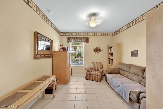 living room featuring light tile patterned floors and ceiling fan