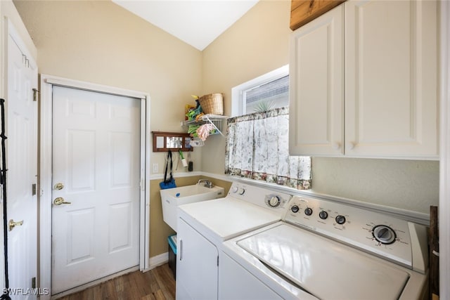 clothes washing area with cabinets, dark hardwood / wood-style floors, washing machine and dryer, and sink