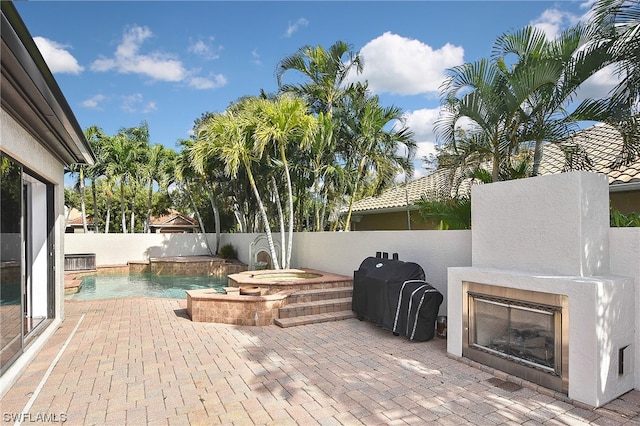 view of patio with pool water feature and a swimming pool with hot tub