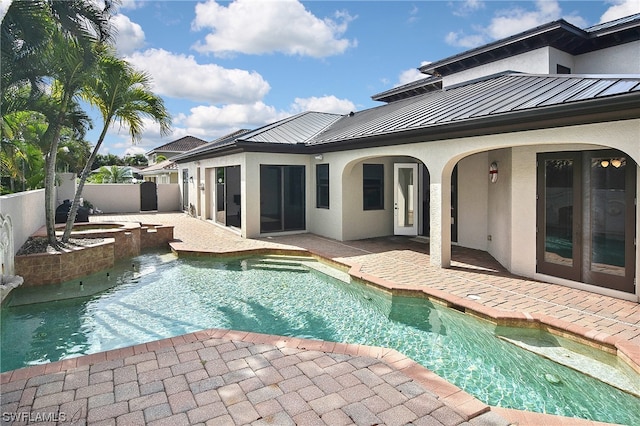 view of swimming pool featuring an in ground hot tub and a patio