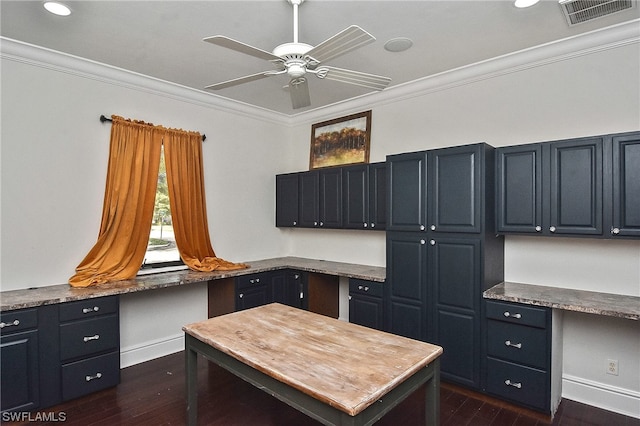 office space featuring crown molding, built in desk, and dark hardwood / wood-style floors